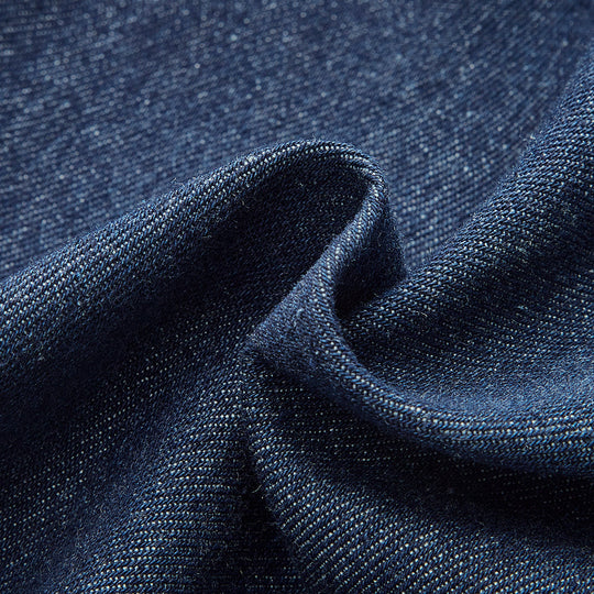 Close-up of blue denim fabric with a subtle pattern