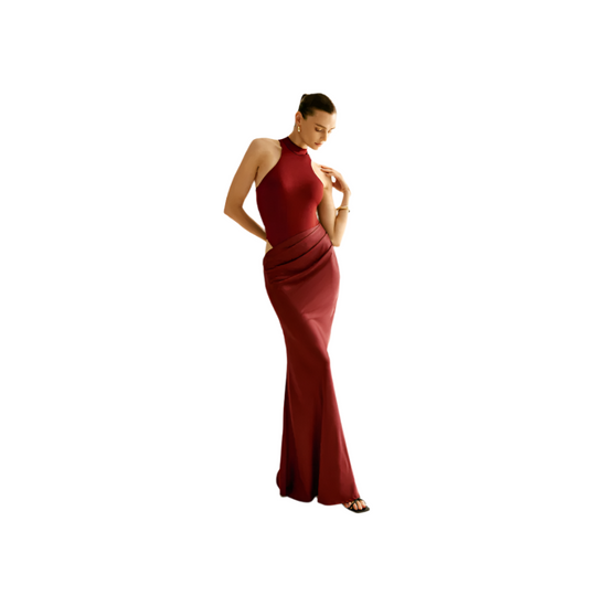 Woman wearing a red evening gown against a plain background