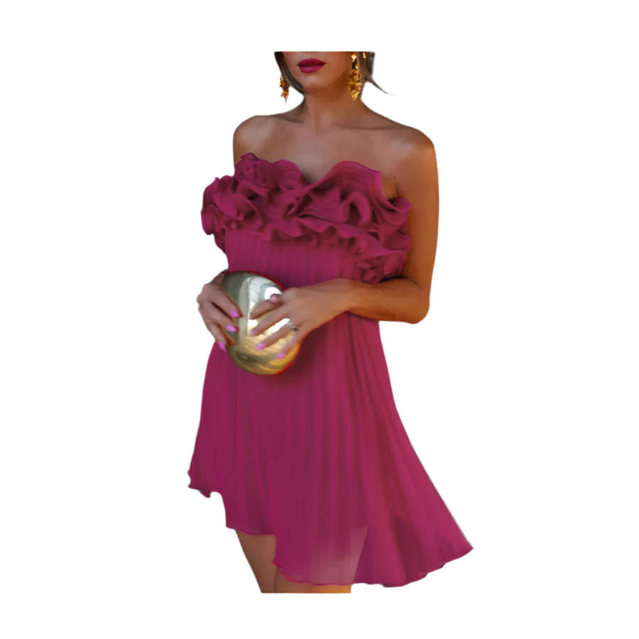 Woman wearing a strapless pink dress holding a gold clutch against a black background