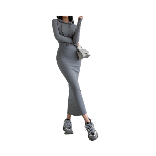 Person wearing a gray outfit with matching shoes and handbag against a white background